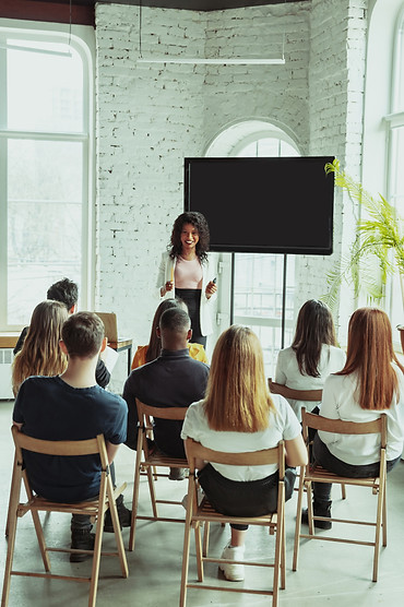 female-african-american-speaker-giving-presentation-hall-university-workshop.jpg