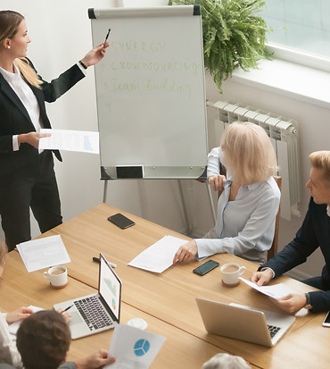 businesswoman-leader-giving-presentation-explaining-team-goals-group-meeting.jpg