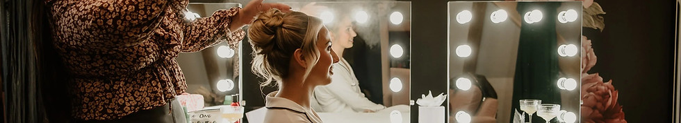 bride has hair styled at wedding