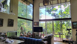 Orotina, Costa Rica home for sale with 3 bedrooms, 2 baths and den for $250K- glass wall to forest and mountains. 
