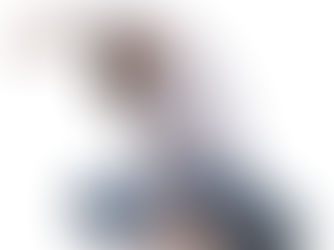 woman stretches to her side while sitting cross legged on the floor