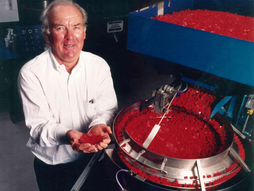 Gordon Gilroy, founder of Summit Packaging Systems, alongisde an F-83 actuator production line at the Northern American Headquarters in Manchester, NH.