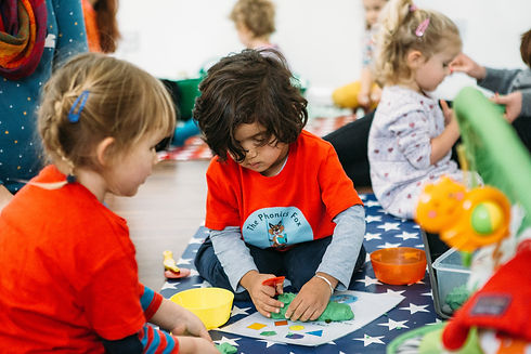 Child playing with play doh in Phonics Fox class
