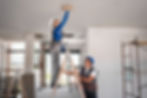 Reforma e manutenção em casas e apartamentos pela Metafluxo Engenharia. Dois pedreiros realizando serviço de pintura serviço de gesso no teto de um apartamento