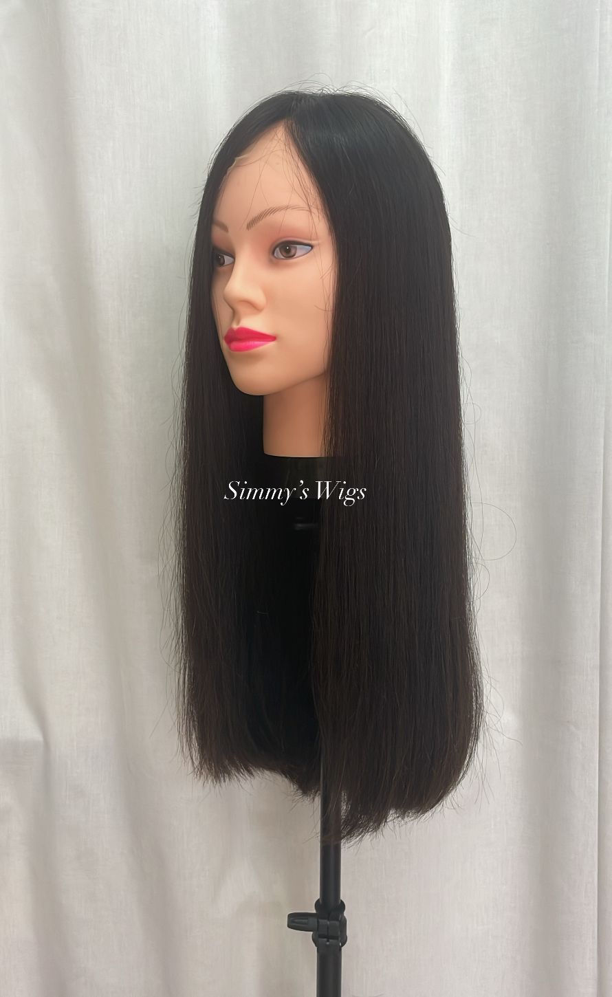Thumbnail: Simmy's Wigs logo, mannequin head with long dark brown human hair wig, white backdrop.