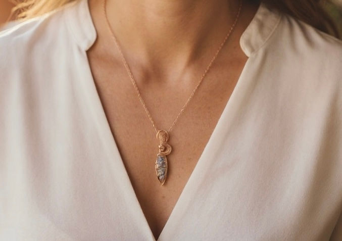 Copper Wire-Wrapped Orthoceras Fossil Pendant with Clear Quartz worn by a women