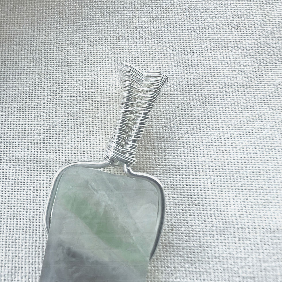 Thumbnail: Close up of Raw Fluorite Pendant wrapped in Silver Wire