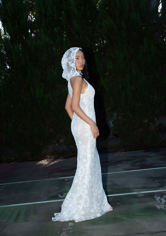 KAI halter gown in ASTON exclusive crochet lace, featuring a high halter neckline with sweeping sides for a flattering silhouette, lined in soft nude tulle for a semi-sheer finish.