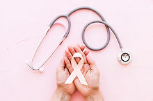 white-awareness-ribbon-in-two-hands-with-stethoscope-on-pink-background.jpg