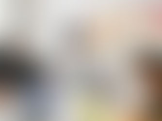 people doing a brainstorm session with sticky notes and sitting on laptops