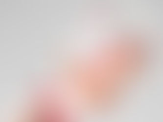 someone with red painted finger nails holding bottle of Chanel coco mademoiselle perfume