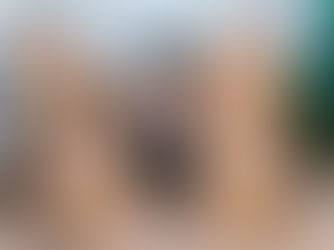 female in front of moving boxes, smiling