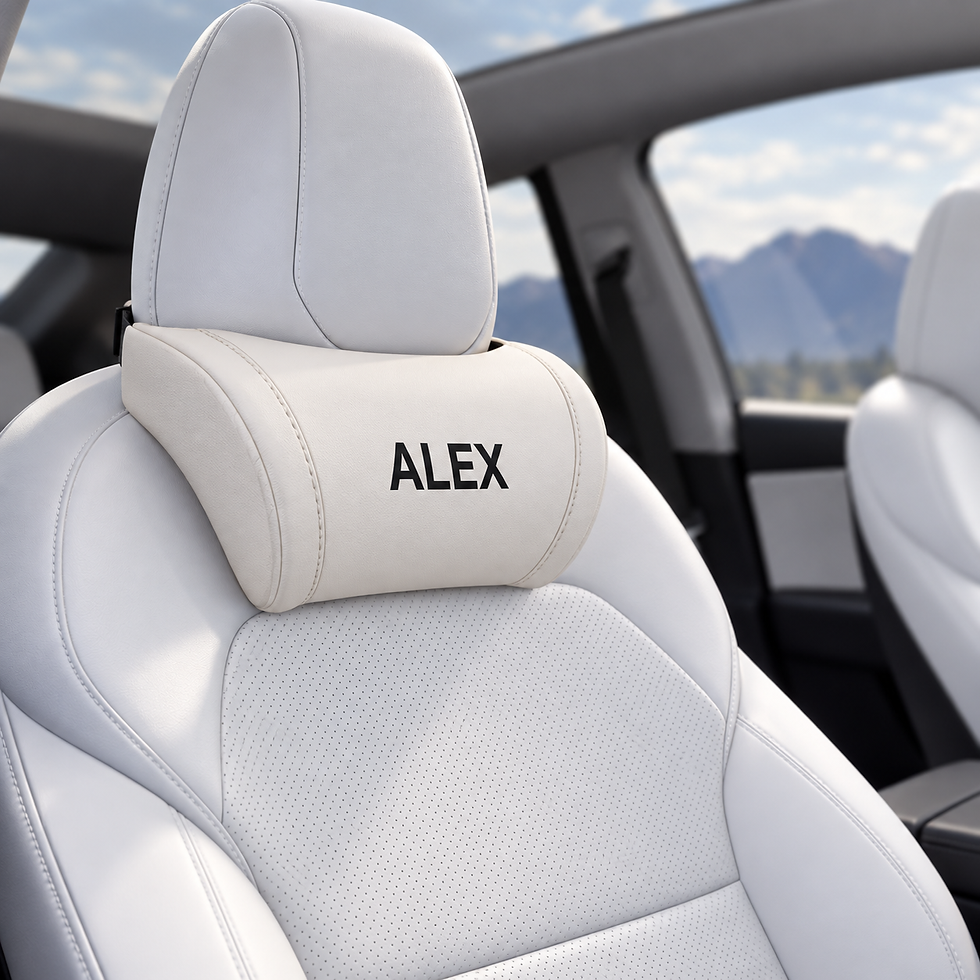 White personalized neck pillow with black ALEX lettering attached to a white Tesla front seat.