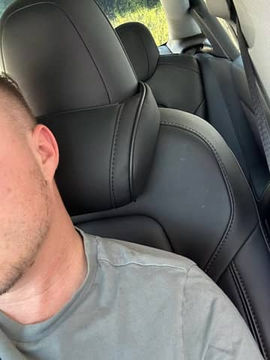 Customer with Black Tesla Neck Pillow