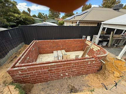 Early construction stage of a custom swimming pool with structural framework in place in S