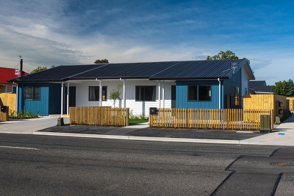 Wide angle view of a suburban house exterior with a clear sky