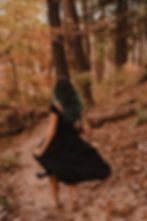 running barefoot down wooded path as if to imply leaving society for a more unconventional nature based life