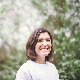 Siming portrait image of Jules in a white jumper