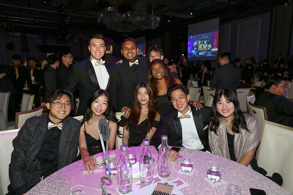 Group photo of a dinner gala event celebrating the success of the team