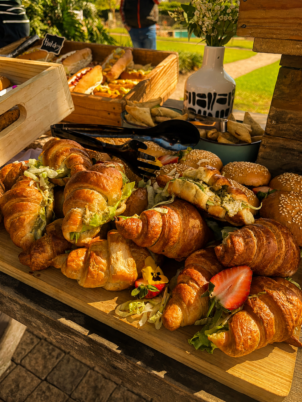 Sunny picnic spread with croissants and sliders