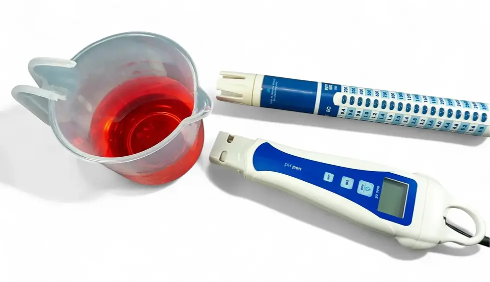 Digital EC meter, pH pen, and measuring cup with water on a white background
