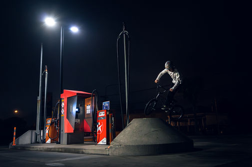 BMX rider jumping concrete structure at night in Christchurch