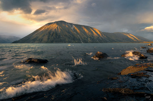 Stormy sunset across Lake Ohau and mountains, Mckenzie Country