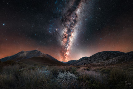 Milky Way rising in between mountains and alpine plants