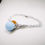 Thumbnail: Bracciale chiama angeli smaltato azzurro strass arancione