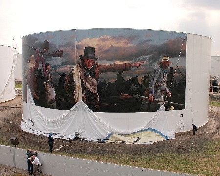 EPICArt mural being installed around a large white industrial storage tank