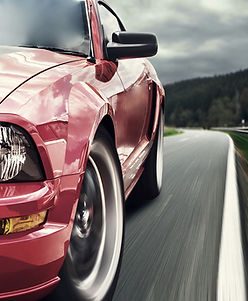 Close picture of red sportscar from the front driver's side bumper