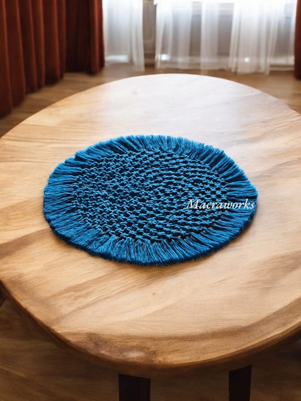 a round table mat of 9 inch width made using ferozi blue coloured macrame threads knotted in a circu