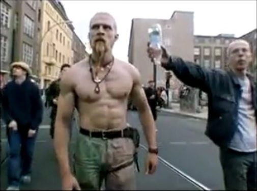 Muscular man dancing and pointing in a street parade