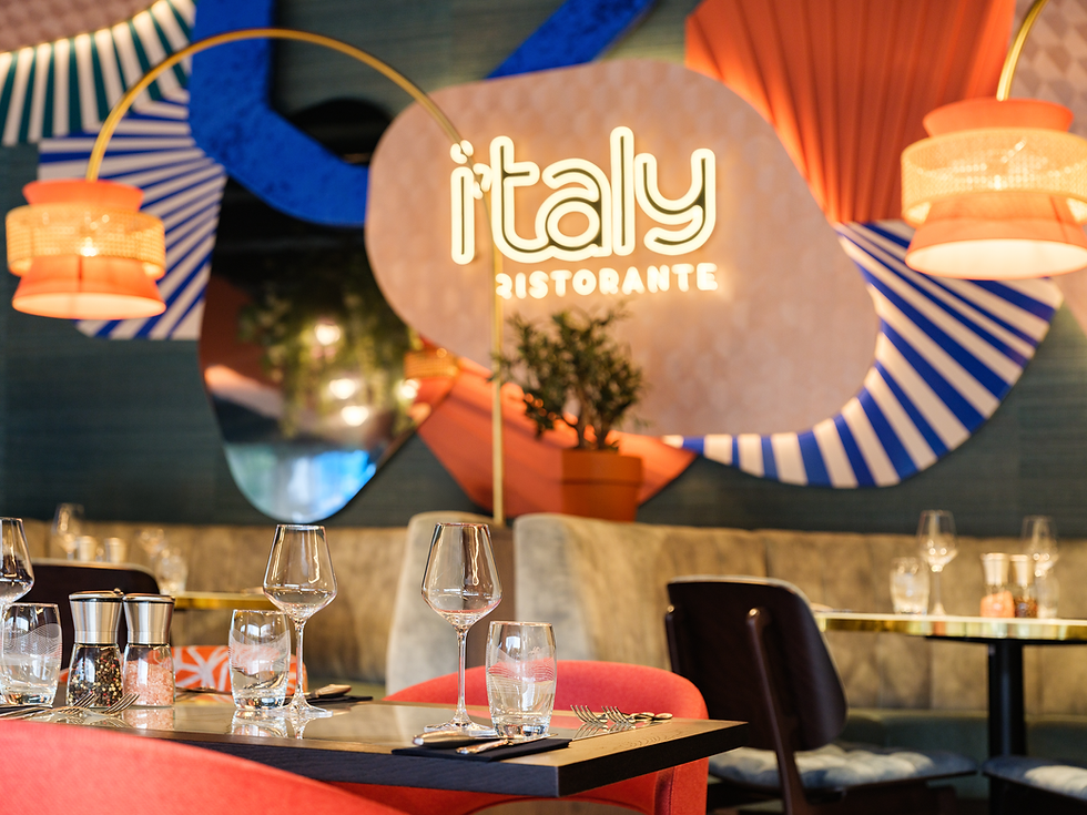 Served Italian specialties at i'taly Ristorante – fresh pasta, pizza and Mediterranean dishes on an elegantly set table.
