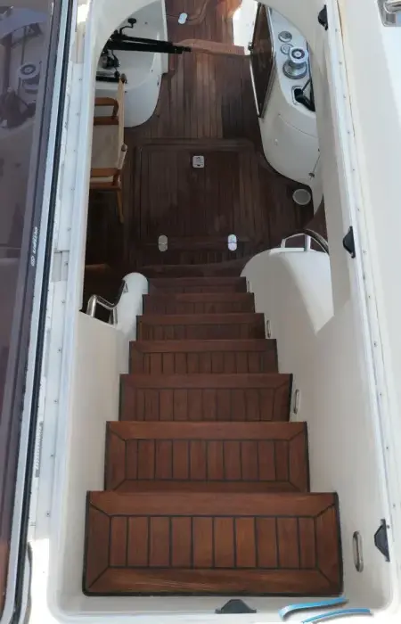Wooden companionway stairs inside the Humilitas I Rodman 56 yacht