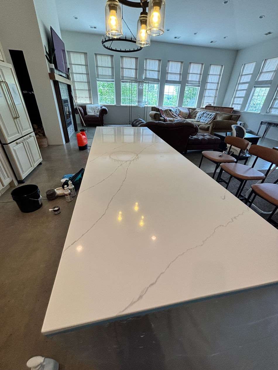 Before and after comparison of quartz countertop refinishing, showing restored shine and color.