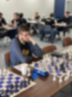 Tournament participant focused on the board in front of him.