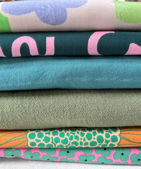 A pile of dressmaking fabrics