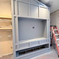 Light gray media wall under construction.