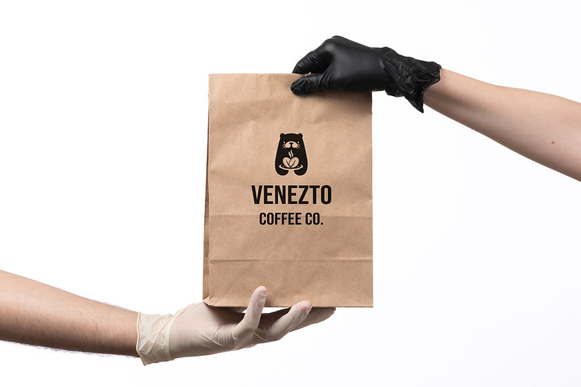 front-view-brown-paper-package-with-food-inside-being-delivered-from-female-to-male copy.j