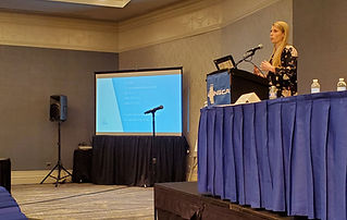 Dr. Lauren at a conference speaking on women's health research as an expert on women's fitness and nutrition