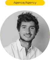 Portrait d'un homme souriant, texte Agence/Agency, dans un cadre rond.