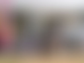 A junior athlete leads the field wearing blue and yellow jersey. 