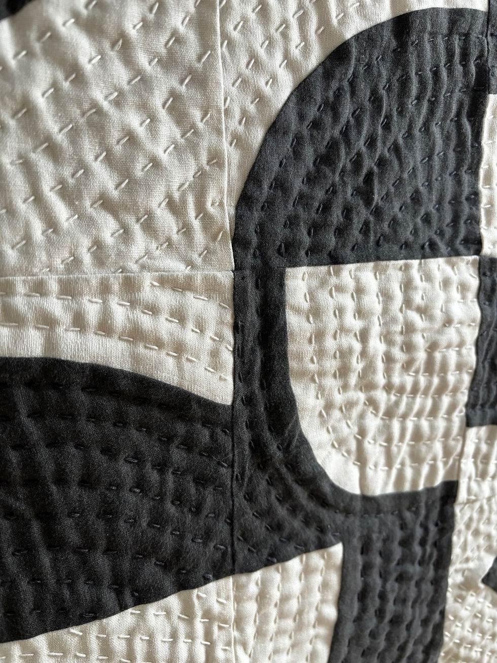 Thumbnail: Detail of hand quilting and monochrome patchwork on Dapple wall quilt wall hanging by Beth Osment Textiles