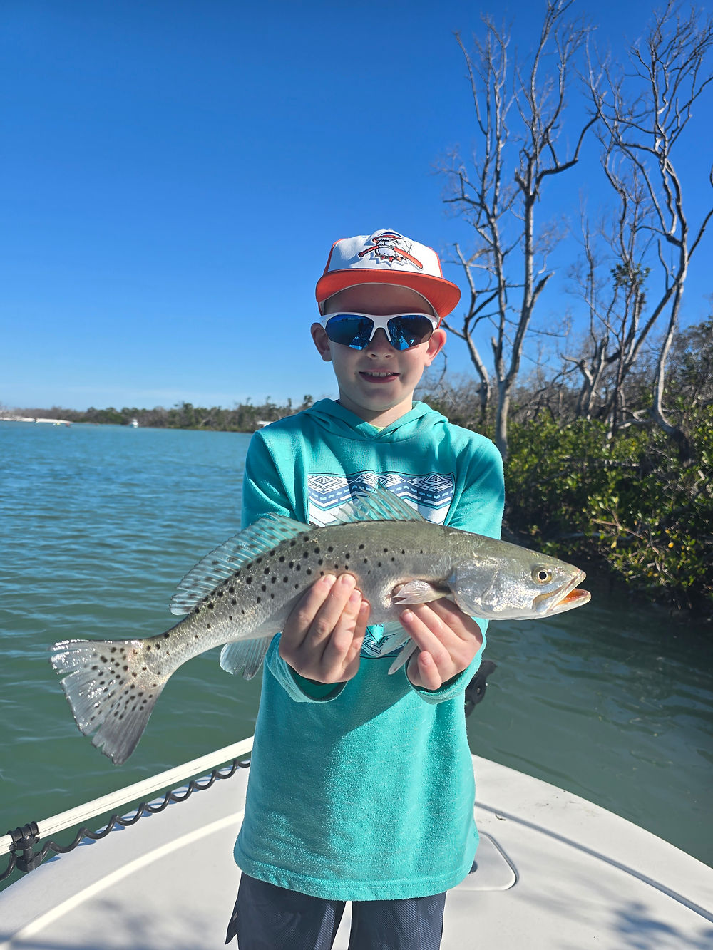 young angler catches a trout on his inshore fishing charter