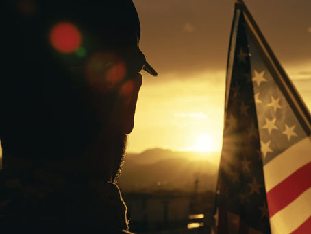 a veteran solutes the American flag