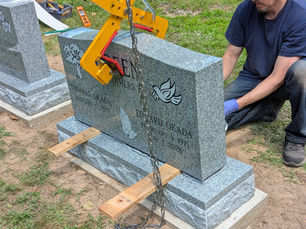 Setting a traditional gravestone in a cemetery