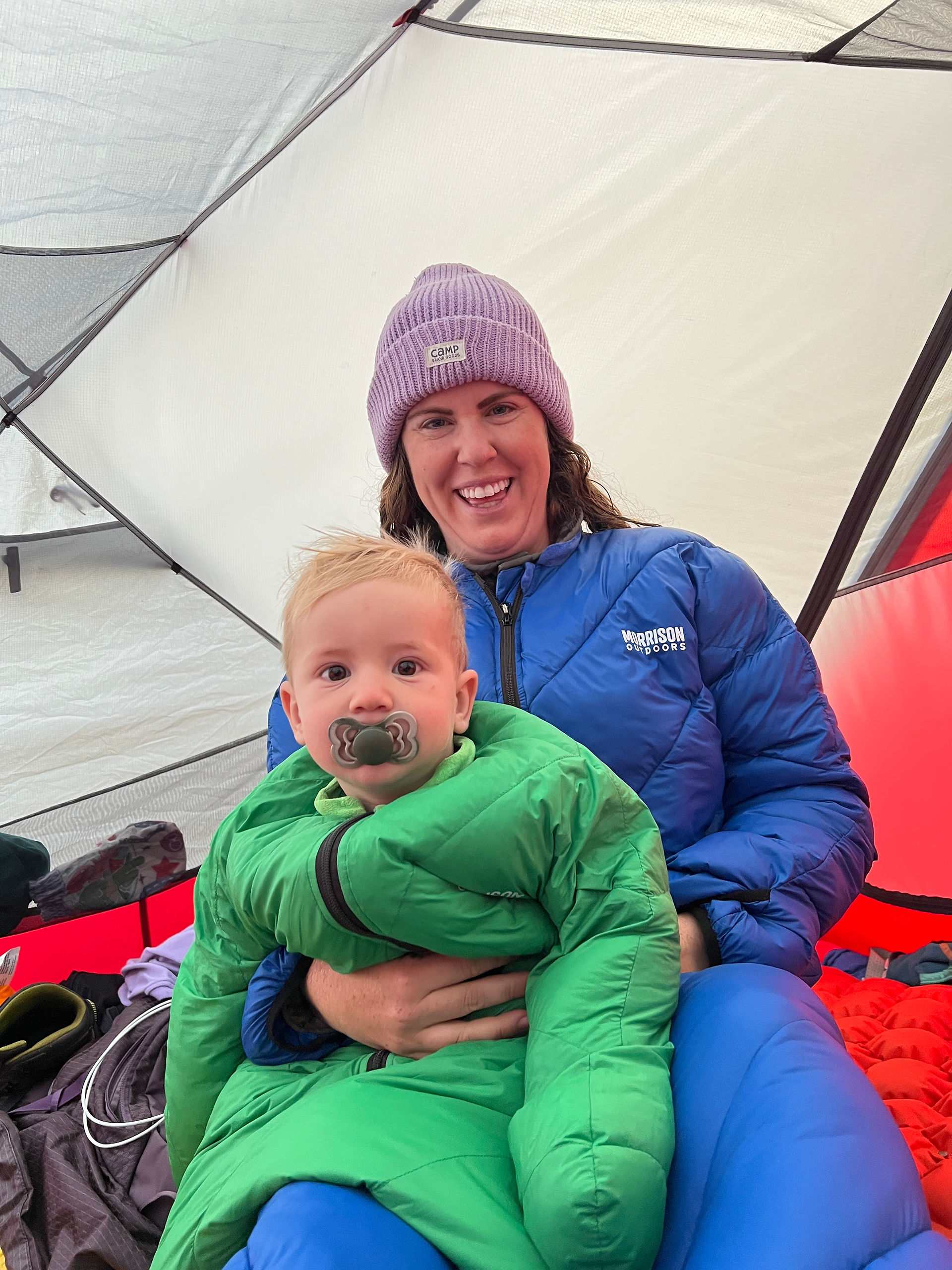 mom and baby camping in a tent
