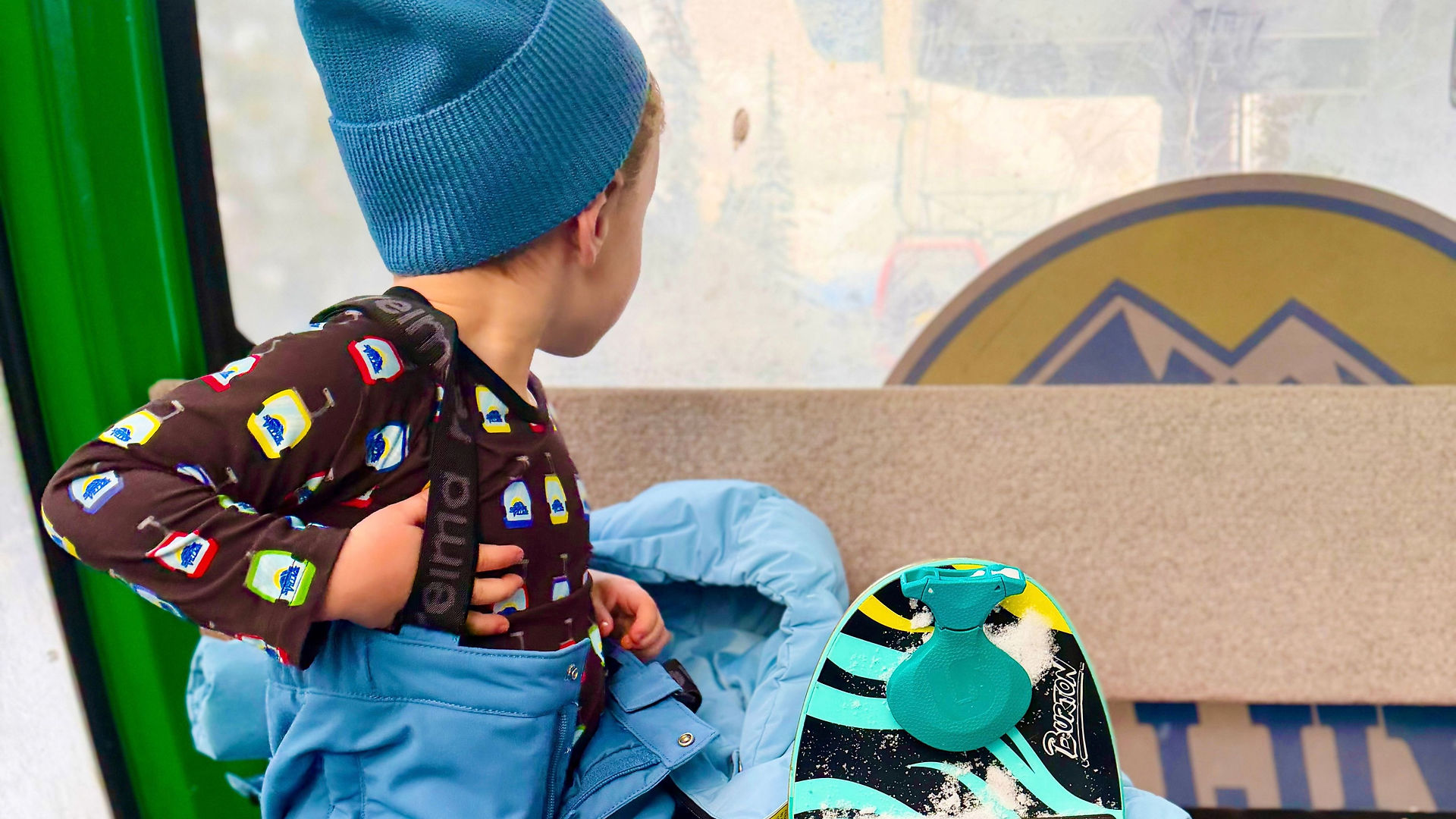 little snowboarder on a gondola