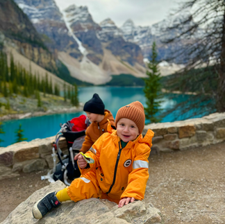 Two toddlers in the canadian rockies wearing their fall layers